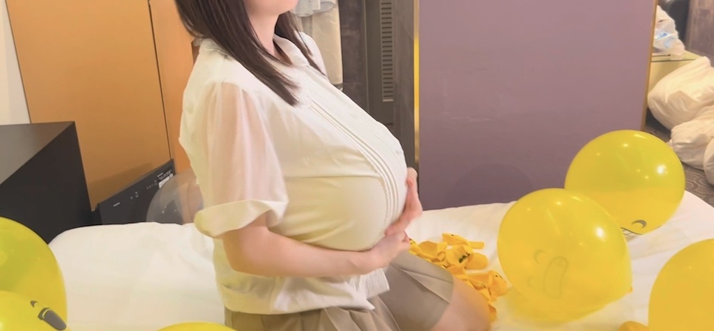 ブラウスの中の風船を押さえながら座るひなた