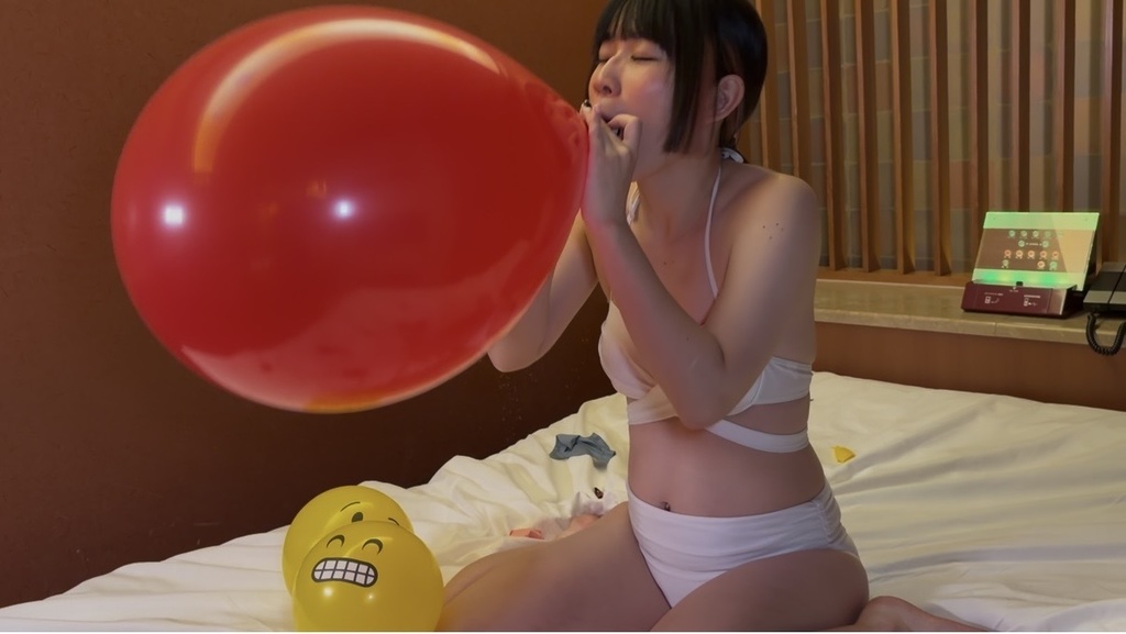 16インチの赤い風船を大きくふくらませる桜井かのんさん